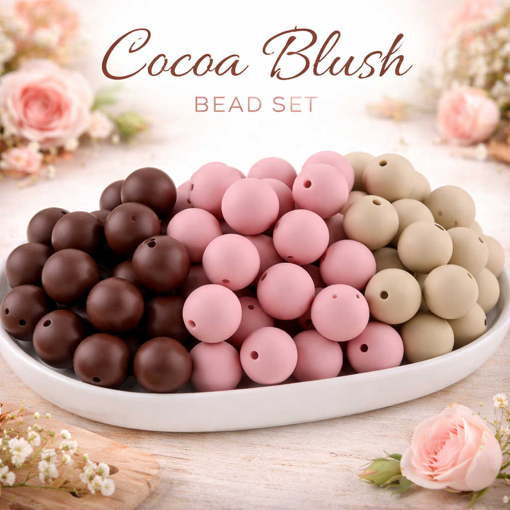 Cocoa Blush bead set with brown, pink, and beige beads on a white plate with flowers in the background.