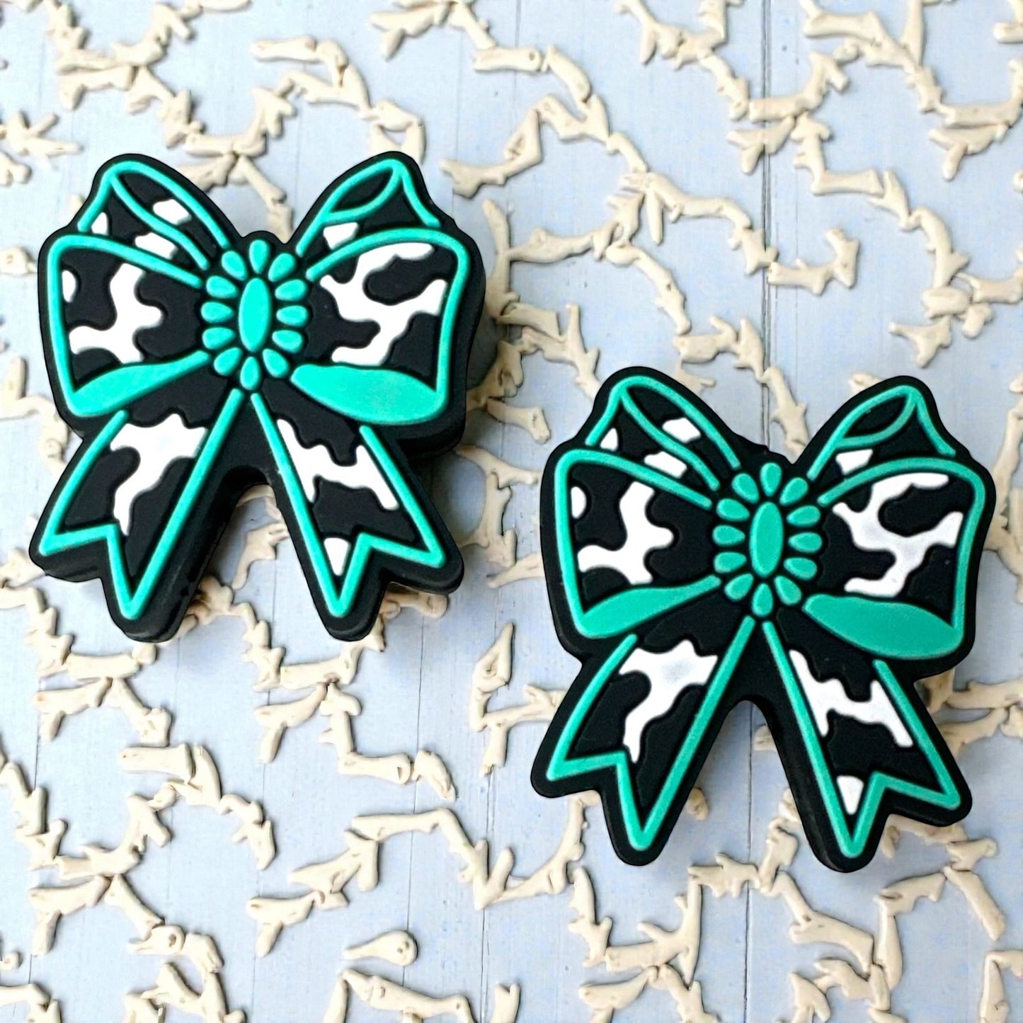 X034-  “Cow Print Turquoise Bow” Silicone Focal Bead (1 Count)